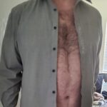 Jon standing in a great dress shirt unbuttoned, showing his torso. 